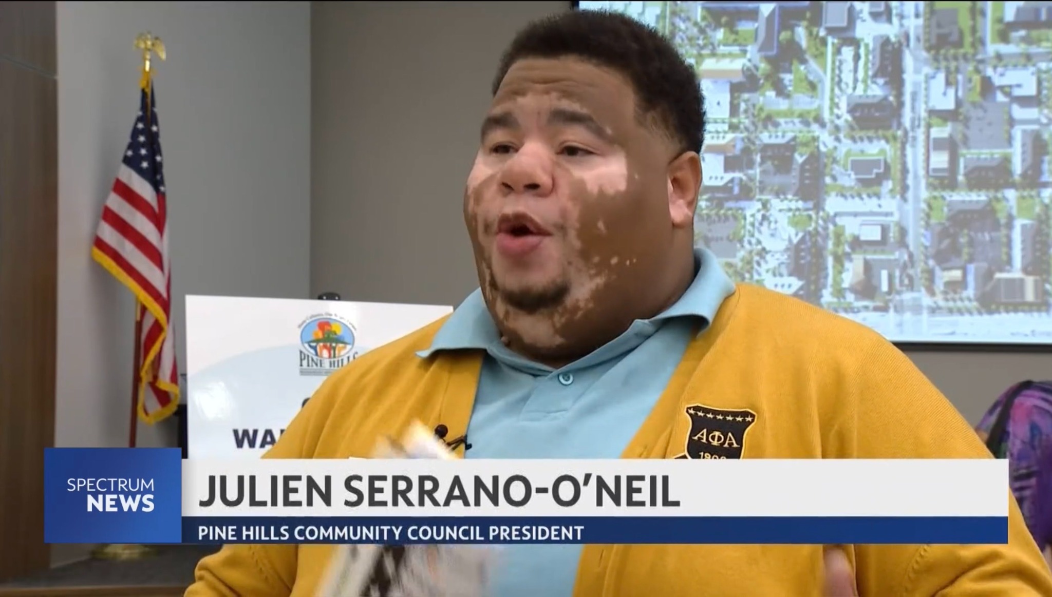 Julien speaking in a televised interview